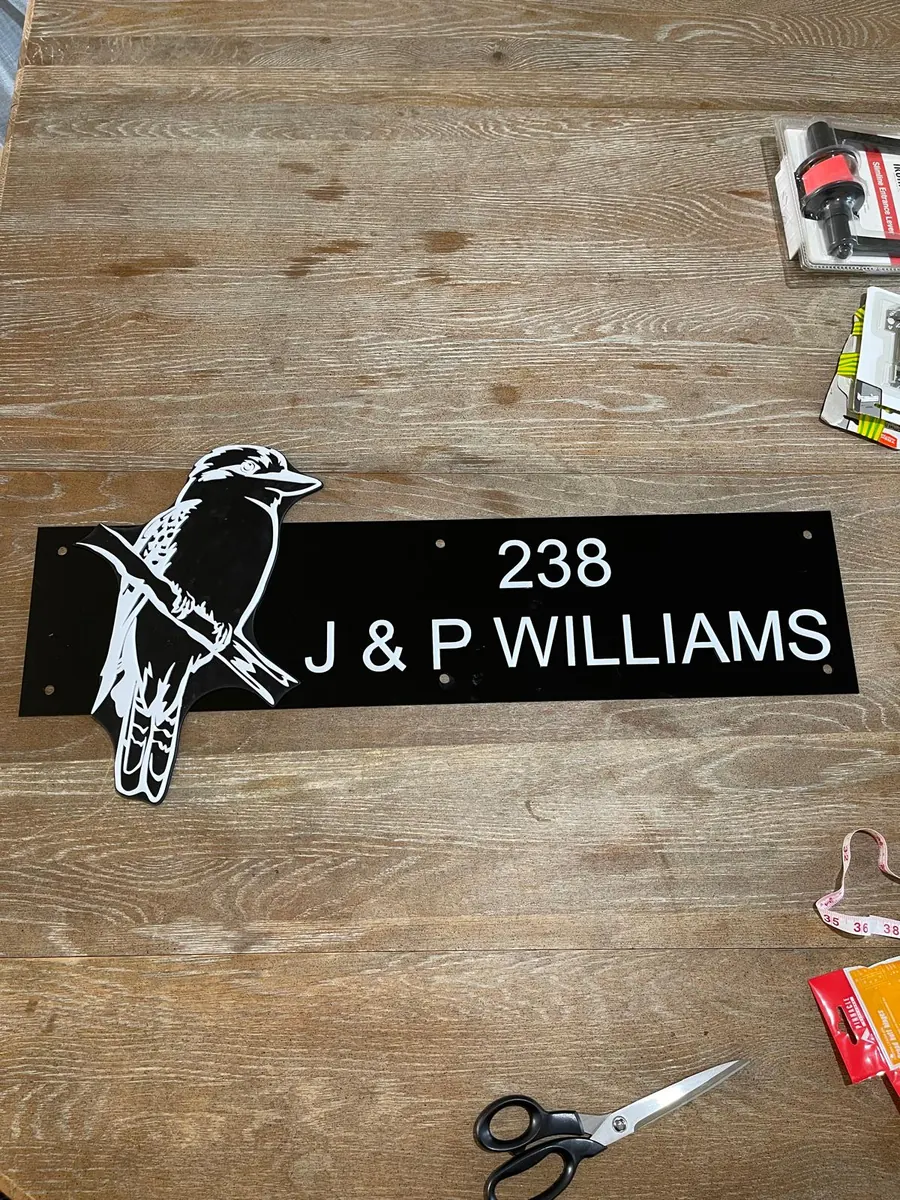 Laser cut two-tone acrylic house number sign reading 238 J and P Williams with a cut kookaburra silhouette