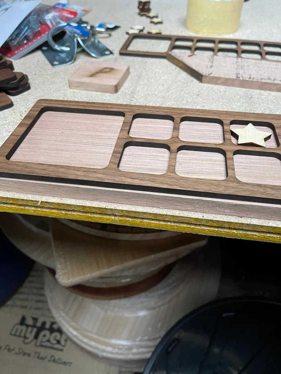 Laser cut timber desk organiser tray in walnut and pale wood with inlaid compartments