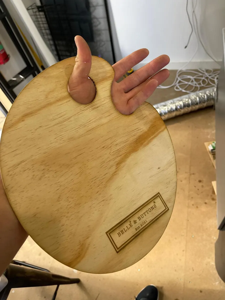 Oval timber serving board with a laser engraved business logo and established date